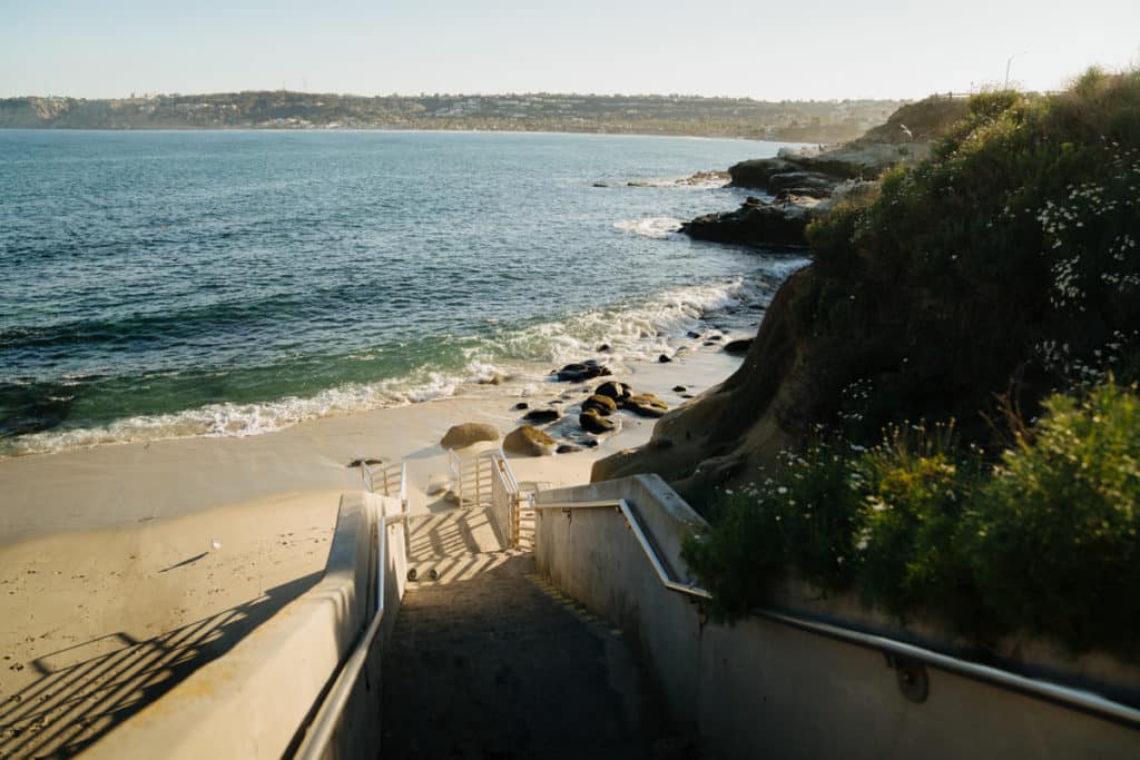 A staircase is leading down to the beach at La Jolla Cove.