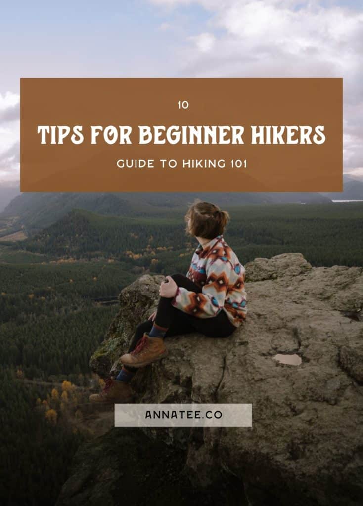 A graphic for Pinterest. The background photo is a woman sitting on a cliff, with mountains behind her. The text says "10 hiking tips for beginners."