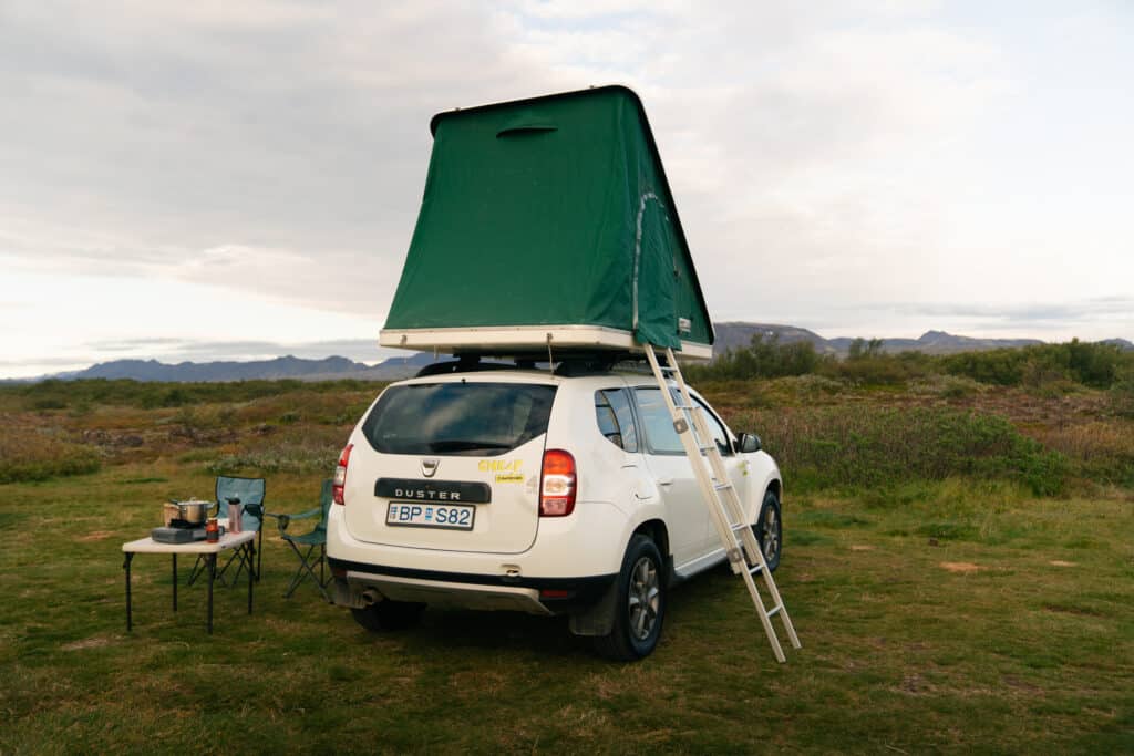 Our car camping setup, with a popup tent on the roof. The car is parked at Thingvellir National Park.