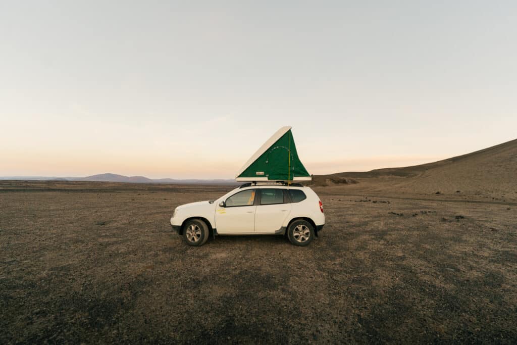 A car camper with a popup tent at one of the best campsites in Iceland.