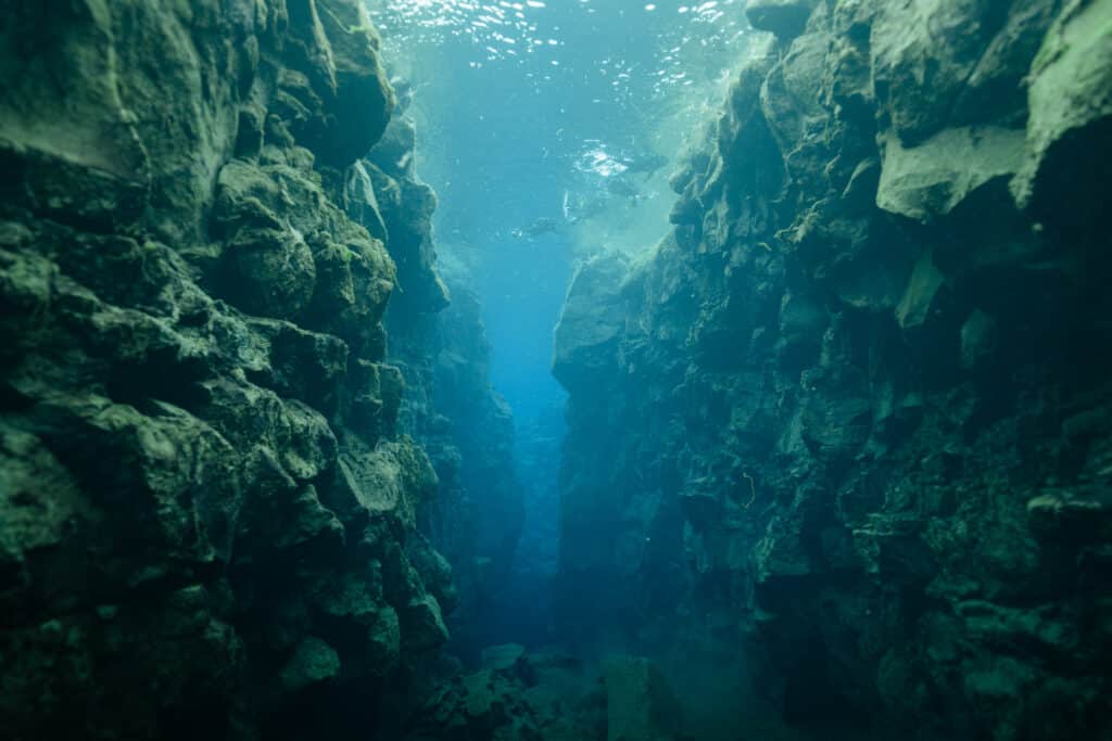 Snorkelers on the surface above the Silfra Fissure in Iceland.