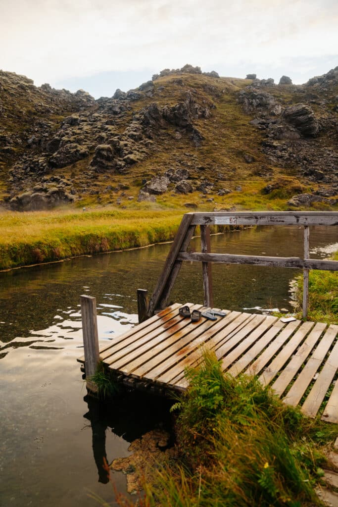Wooden steps leading into Landmannalaugar Bathing Place, one of the best hot springs in Iceland.