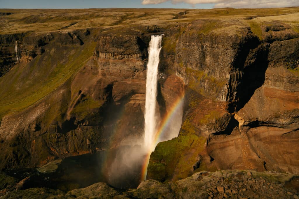A view of Haifoss, one of the best waterfalls in Iceland, tumbling into the canyon with a rainbow.