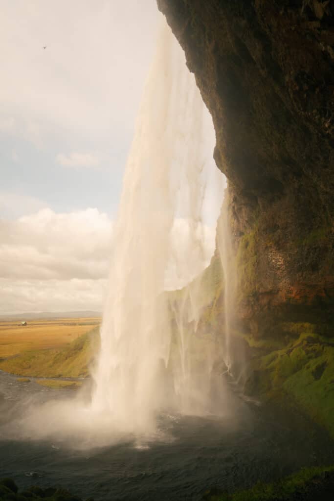 The view from behind Seljalandsfoss, which is one of the best waterfalls in Iceland that you can walk behind.