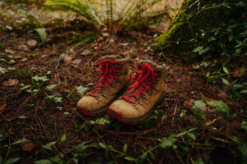 A pair of Danner boots in the grass. Hiking boots are a great gift for outdoorsy women!