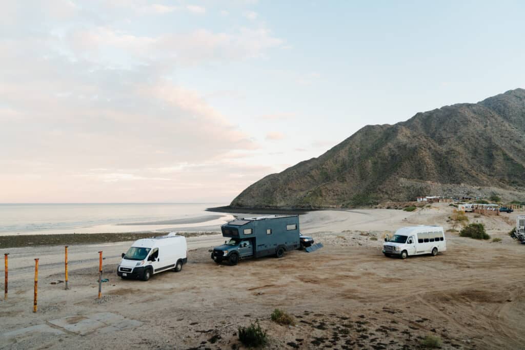Three vans parked along one of the stops on this Baja road trip itinerary - a beach in San Felipe.